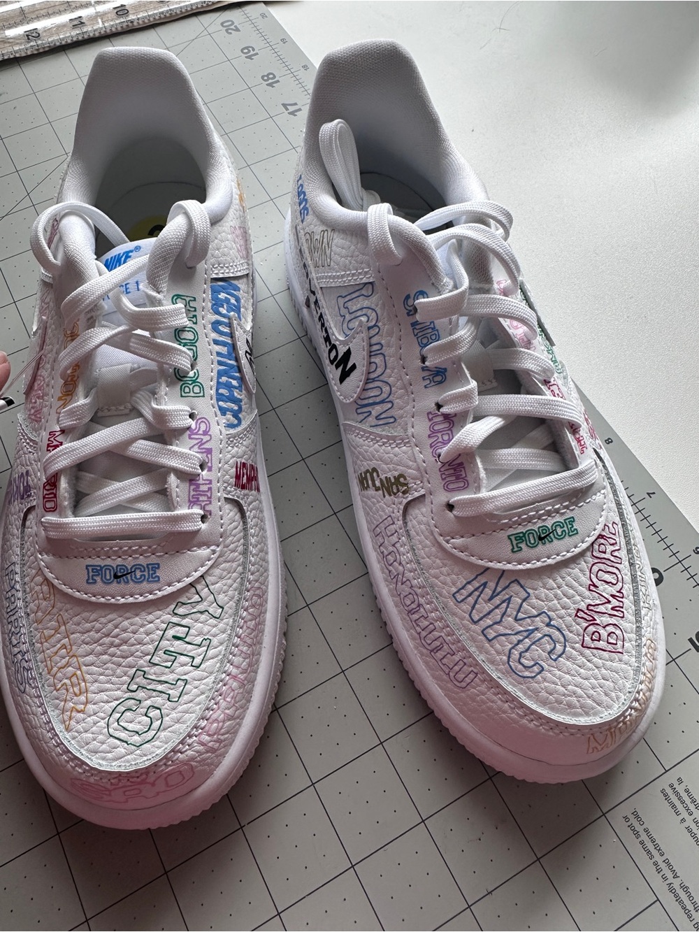 Nike Kids White Sneakers with Multicolor Lettering